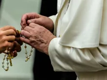 Pope Francis holds a rosary during a general audience Aug. 7, 2019. 