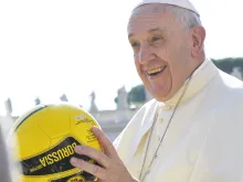 Pope Francis holds a soccer ball in St. Peter's Square during the Wednesday general audience on Aug. 26, 2015. L'Osservatore Romano.