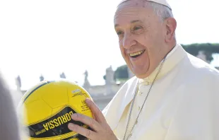 Pope Francis holds a soccer ball in St. Peter's Square during the Wednesday general audience on Aug. 26, 2015. L'Osservatore Romano.  