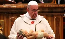 Pope Francis holds a statue of the Christ child for the nativity scene on December 24, 2013. ?w=200&h=150