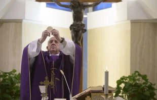 Pope Francis lifts the Eucharist during Mass March 31, 2020.   Vatican Media.