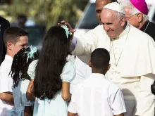 Pope Francis is greeted by children in Santiago de Cuba, Sept. 22, 2015. 