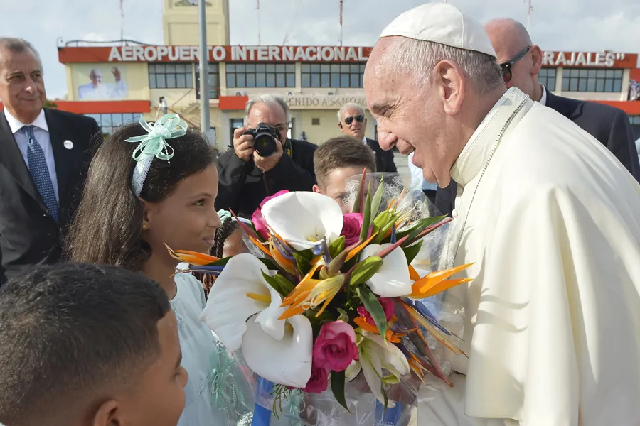 Pope Francis is greeted by children with flowers in Santiago de Cuba on Sept. 22, 2015. ?w=200&h=150