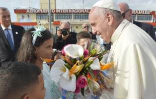 Pope Francis is greeted by children with flowers in Santiago de Cuba on Sept. 22, 2015.   (C) L'Osservatore Romano.