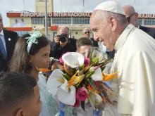 Pope Francis is greeted by children with flowers in Santiago de Cuba on Sept. 22, 2015. 