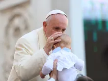 Pope Francis kisses a baby at the general audience in St. Peter's Square, Nov. 11, 2015. 