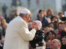 Pope francis kisses a child in St. Peter's Square for the general audience Dec. 9, 2015. 