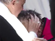 Pope Francis kisses a man suffering from boils in Saint Peter's Square at the end of his Wednesday general audience, Nov. 6 2013.