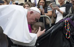 Pope Francis kisses a young child during a special meeting with sick children in New York City, Sept. 25, 2015.   L'Osservatore Romano.