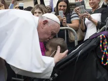 Pope Francis kisses a young child during a special meeting with sick children in New York City, Sept. 25, 2015. 