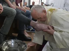 Pope Francis kisses the foot of a prisoner during Holy Thursday Mass April 18, 2019. 