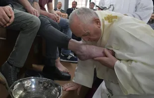 Pope Francis kisses the foot of a prisoner during Holy Thursday Mass April 18, 2019.   Vatican Media.