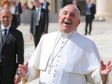 Pope Francis laughs outside St. Peter's Basilica during the April 1, 2015 general audience. 
