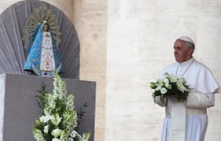 Pope Francis lays flowers at the foot of the statue of Our Lady of Lujan on May 8, 2013.   Stephen Driscoll/CNA.