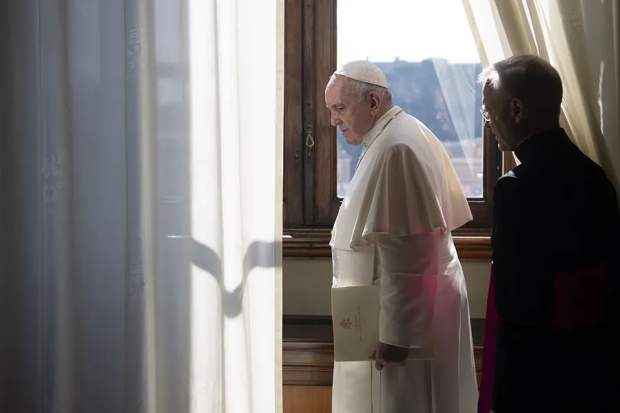 Pope Francis looks out a window of the apostolic palace March 18, 2020. ?w=200&h=150
