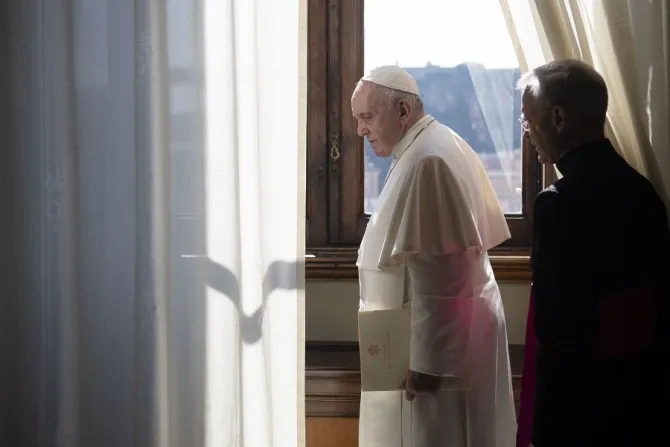 Pope Francis looks out a window of the apostolic palace March 18 2020 Credit Vatican Media