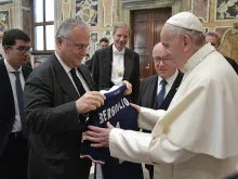 Pope Francis is presented with an S.S. Lazio jersey at his meeting with the Coppa Italia finalists at the Vatican, May 16, 2017. 