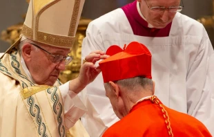 Pope Francis places a red biretta on the head of a new cardinal during a consistory held in St. Peter's Basilica, June 28, 2018.   Daniel Ibanez/CNA.