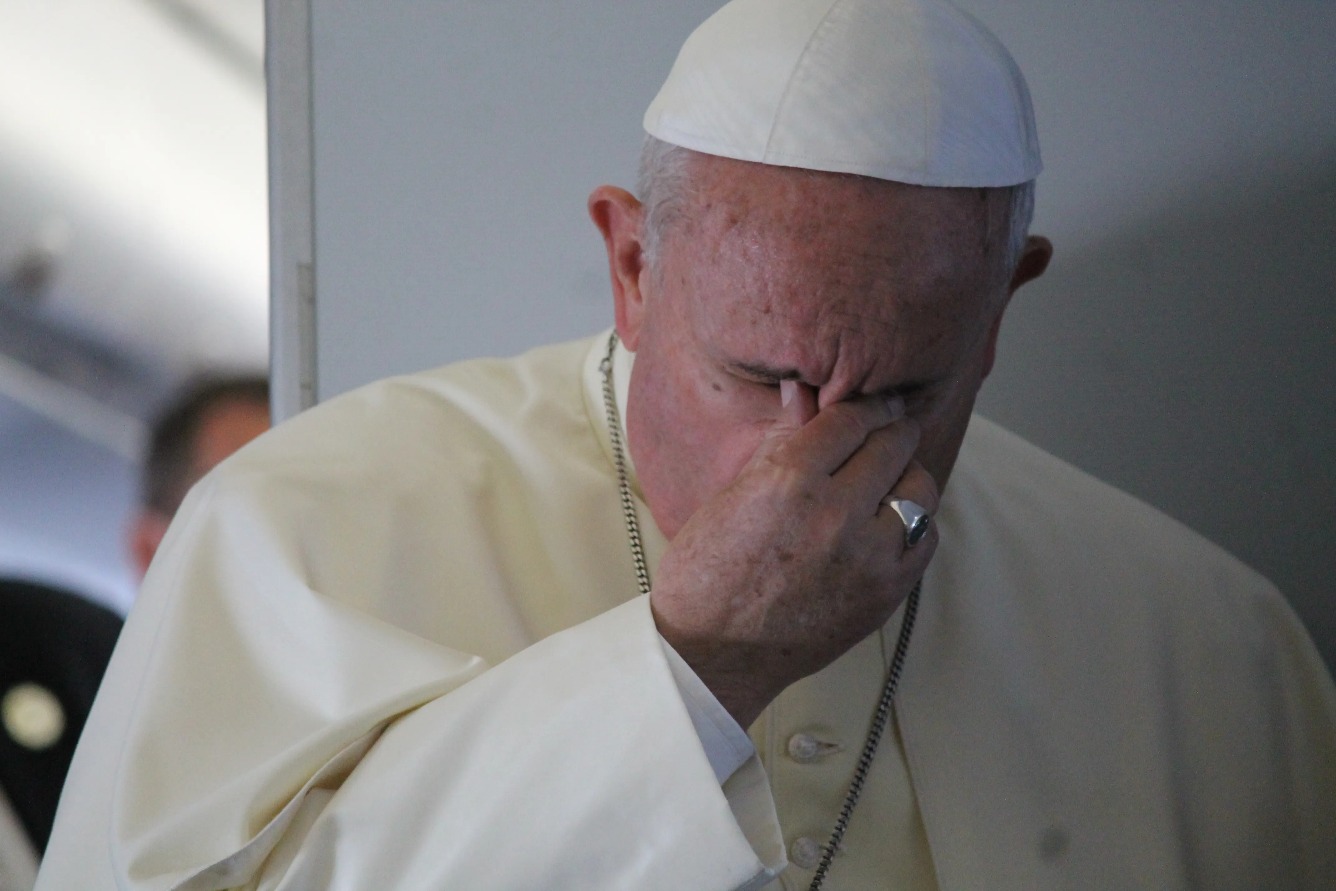 Pope Francis prays with journalists on the papal flight en route to South Korea, August 14, 2014. ?w=200&h=150