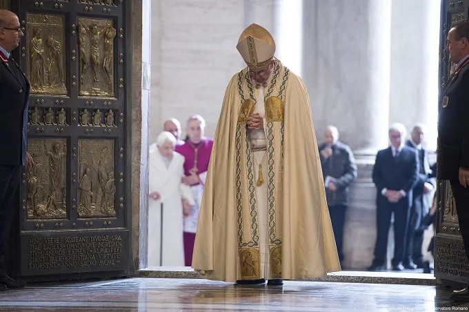 Pope Francis prays after opening the Holy Door in St. Peters Basilica Dec. 8, 2015 launching the extraordinary jubilee of mercy. ?w=200&h=150