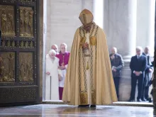 Pope Francis prays after opening the Holy Door in St. Peters Basilica Dec. 8, 2015 launching the extraordinary jubilee of mercy.