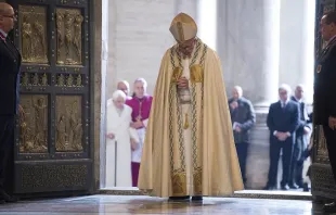 Pope Francis prays after opening the Holy Door in St. Peters Basilica Dec. 8, 2015 launching the extraordinary jubilee of mercy.   LOsservatore Romano.