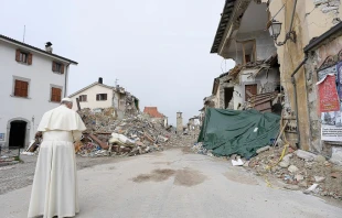 Pope Francis prays at the red zone in Amatrice during a private Oct. 4, 2016, visit to those affected by a massive earthquake in August.   L'Osservatore Romano.
