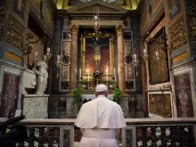 Pope Francis prays before the crucifix of the Church of San Marcello al Corso March 15, 2020. 