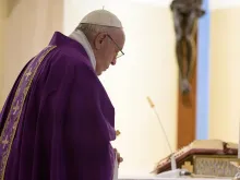 Pope Francis prays in the chapel of Casa Santa Marta March 23, 2020. 