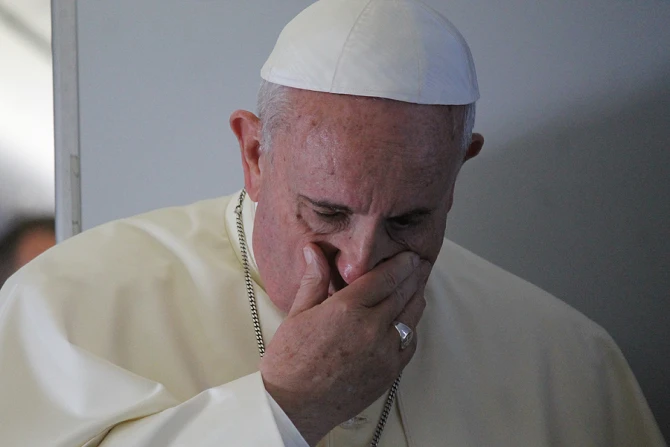 Pope Francis prays with journalists on the papal flight en route to South Korea August 14 2014 Credit Alan Holdren CNA 2 CNA 8 14 142 