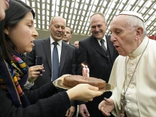 Pope Francis receives a cake for his 80th birthday, Dec. 17, 2016. 