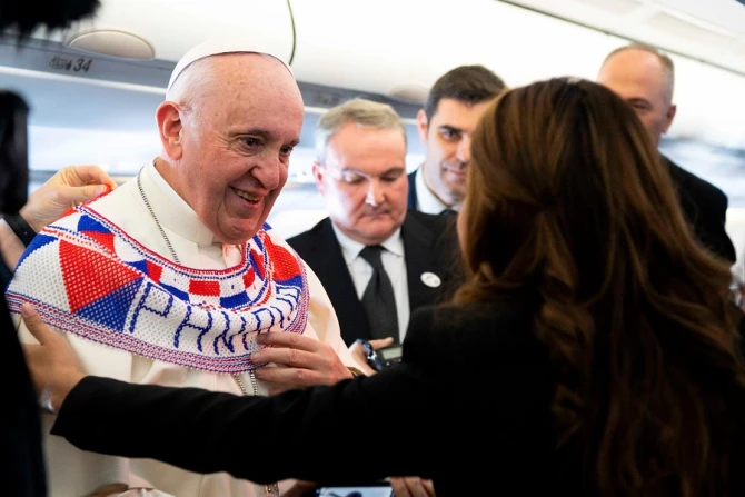 Pope Francis receives a gift aboard the papal plane to Panama Jan 23 2019 Credit Vatican Media CNA