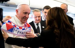 Pope Francis receives a gift aboard the papal plane to Panama Jan. 23, 2019.   Vatican Media.