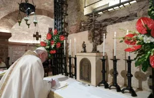 Pope Francis signs his new encyclical, Fratelli tutti, on the altar before the tomb of St. Francis of Assisi on Oct. 3, 2020. Photo  