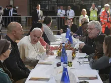 Pope Francis lunches with poor people, refugees, and the 18 prisoners who did not escape, at San Petronio Basilica in Bologna, Italy, Oct. 1, 2017. 