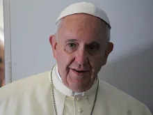 Pope Francis speaks to journalists on the papal flight to South Korea in 2014. 