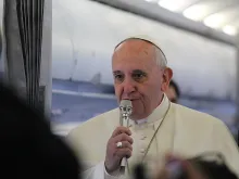 Pope Francis speaks to journalists on the papal plane on his way to Strasbourg, France, Nov. 25, 2014. 
