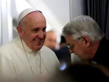 Pope Francis speaks with Holy See press officer Fr. Federico Lombardi during their flight to Sri Lanka, Jan. 12, 2015. 