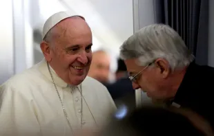 Pope Francis speaks with Holy See press officer Fr. Federico Lombardi during their flight to Sri Lanka, Jan. 12, 2015.   Alan Holdren/CNA.