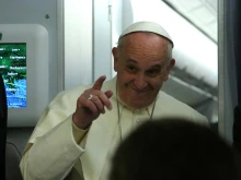 Pope Francis speaks with journalists aboard the papal plane en route to Sri Lanka, Jan. 12, 2015. 