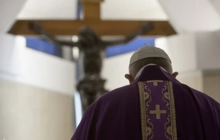 Pope Francis stands in front of the crucifix in the chapel of the Casa Santa Marta April 4, 2020.   Vatican Media.