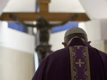Pope Francis stands in front of the crucifix in the chapel of the Casa Santa Marta April 4, 2020. 