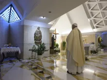Pope Francis stops before a statue of Mary in the chapel of Casa Santa Marta May 4, 2020. 