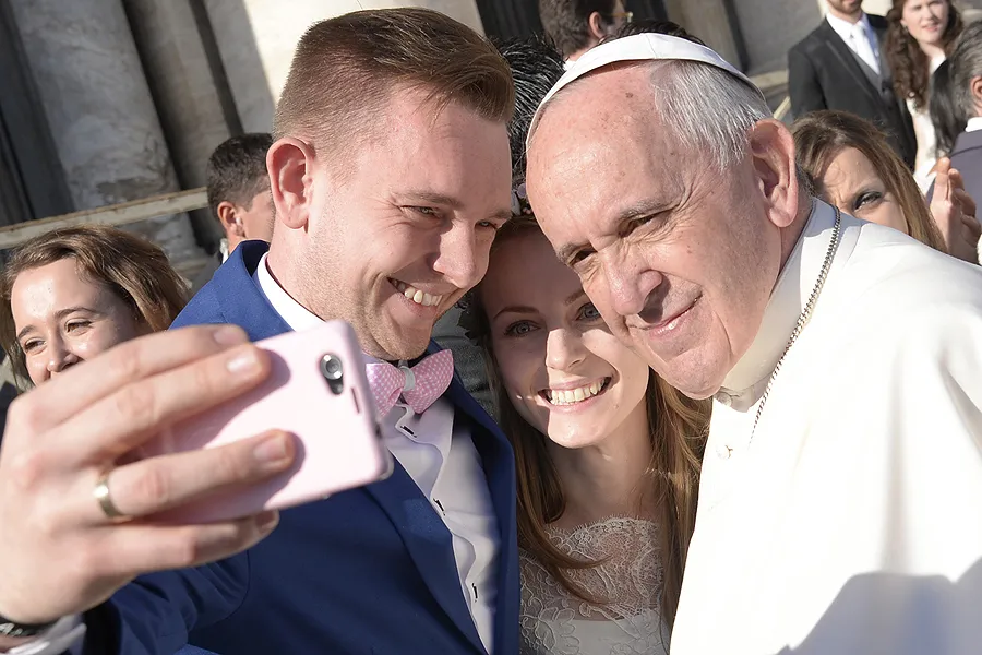 Pope Francis takes a selfie with a newly married couple in St. Peter's Square, Dec. 2, 2015. ?w=200&h=150