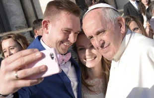 Pope Francis takes a selfie with a newly married couple in St. Peter's Square, Dec. 2, 2015.   L'Osservatore Romano.