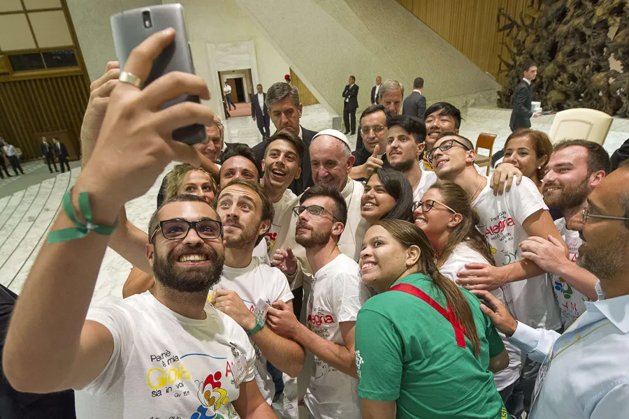 Pope Francis takes a selfie with members of the International Eucharistic Youth Movement in the Vatican's Paul VI Hall, Aug. 7, 2015. ?w=200&h=150