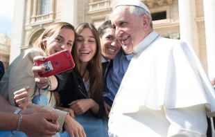 Pope Francis takes a selfie with pilgrims at the April 1, 2015 general audience in St. Peter’s Square.   Vatican Media.