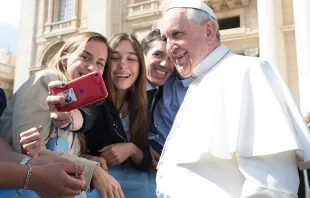 Pope Francis takes a selfie with pilgrims at the April 1, 2015 general audience in St. Peter’s Square. Vatican Media.