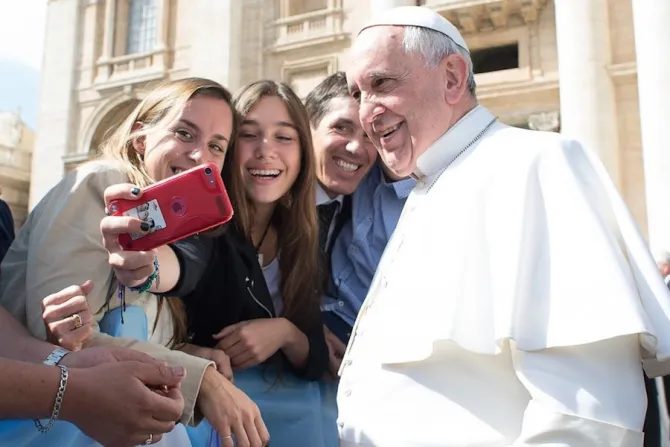 Pope Francis takes a selfie with pilgrims at the April 1 2015 general audience in St Peters Square Credit Vatican Media 