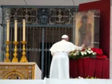 Pope Francis touches an image of Mary at the Sept. 7 prayer vigil for peace. 